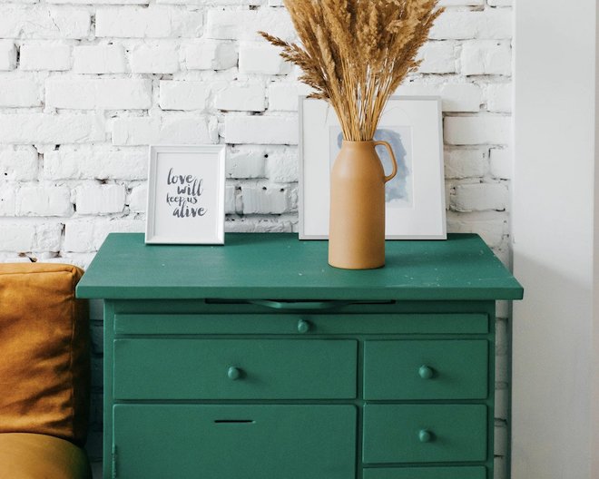 drawer with a plant and two ictures on it